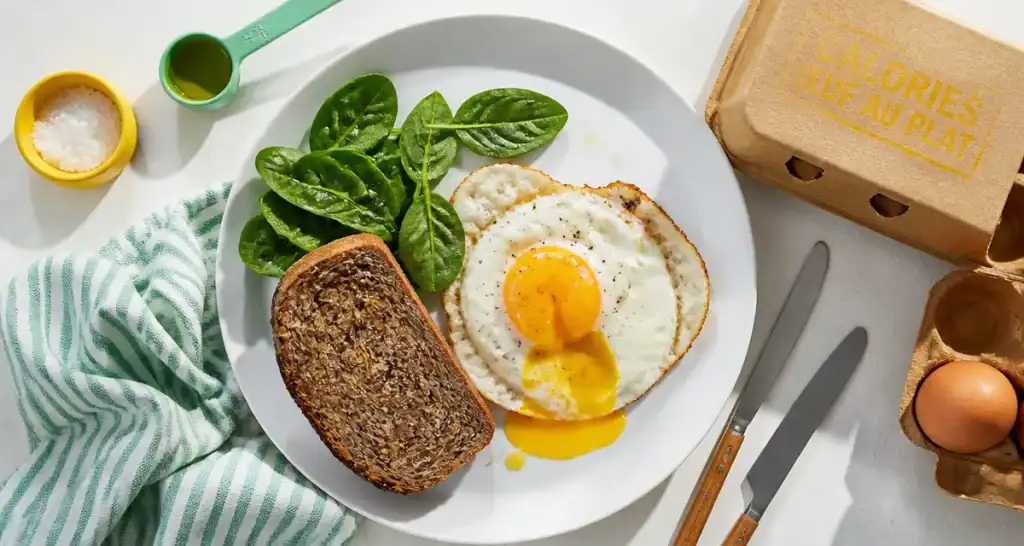 calorie oeuf au plat sur assiette avec pain et épinards